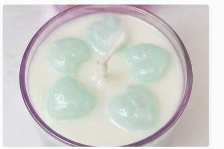 Fresh linen candle with heart floating